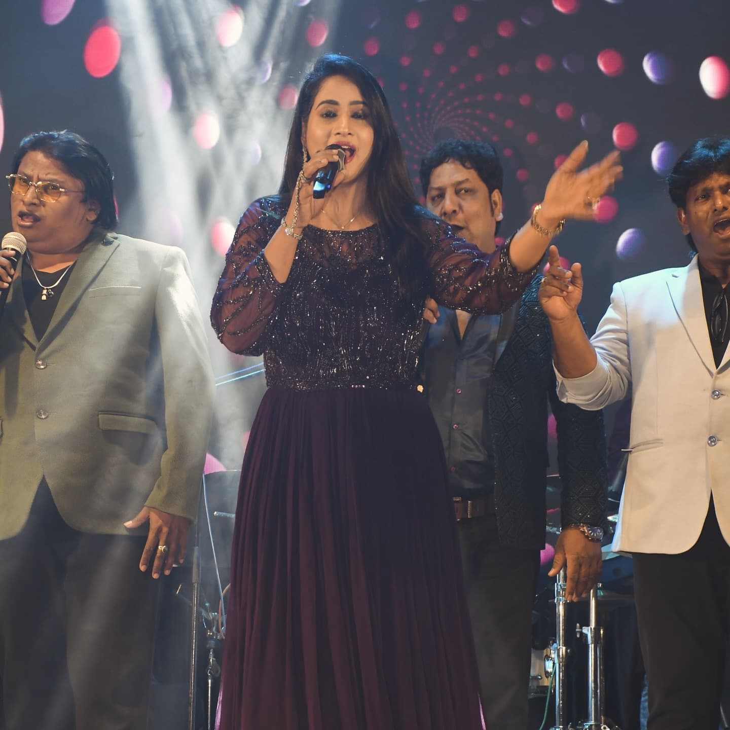 Kkomal Krusshna singing at event with live band