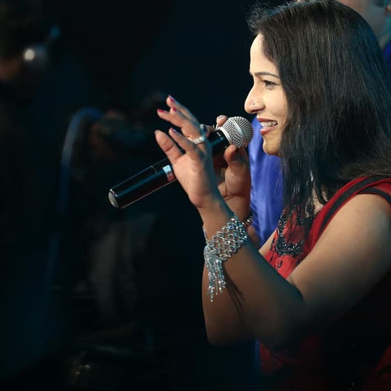 Kkomal Krusshna on stage with band